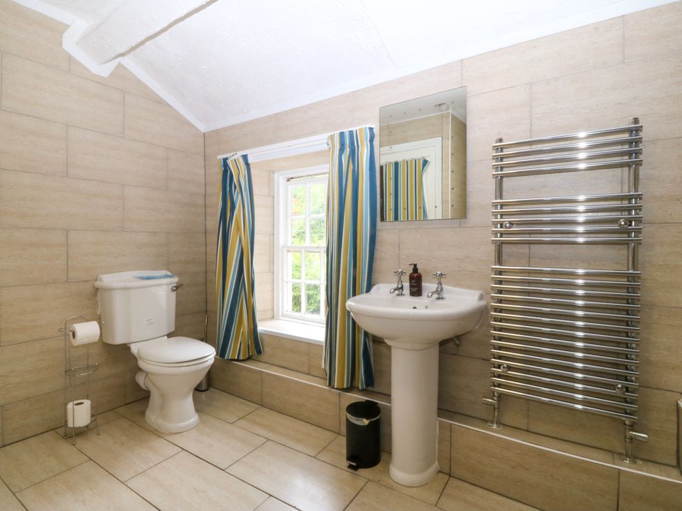 A bathroom with a shower, toilet, and sink at Ty Mawr in Criccieth