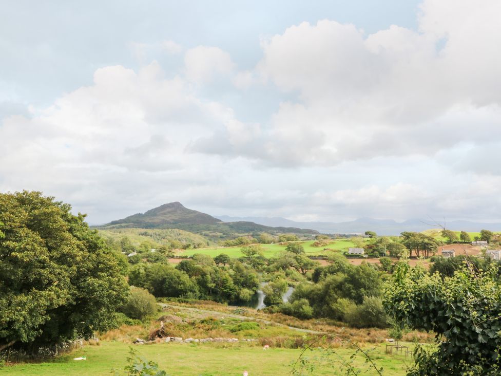 A landscape view with mountains and trees at Ty Mawr in Criccieth