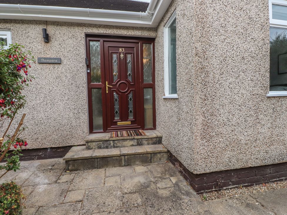 An entrance with a brown door at Nampara in Colwyn Bay