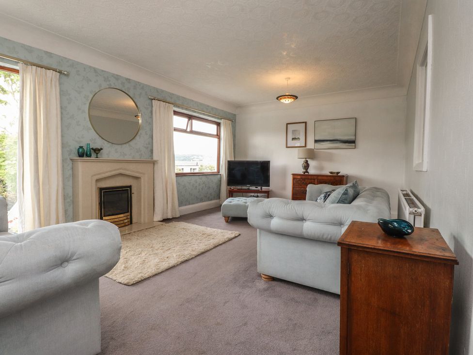 A living room with a sofa and a television at Nampara in Colwyn Bay