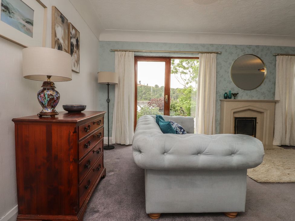 A living room with a sofa and lamp at Nampara in Colwyn Bay