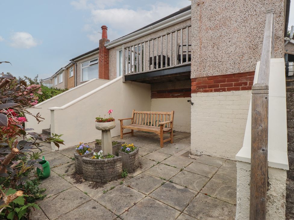 An outdoor area with a bench and a planter at Nampara in Colwyn Bay