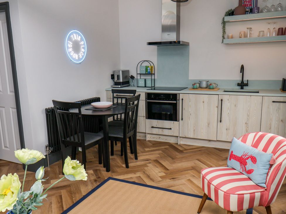 A kitchen with table and chairs at Apartment Blue in Whitby