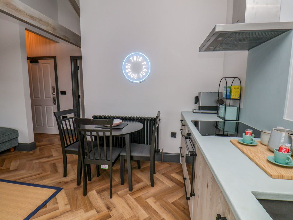 A kitchen with a dining table and chairs at Apartment Blue in Whitby