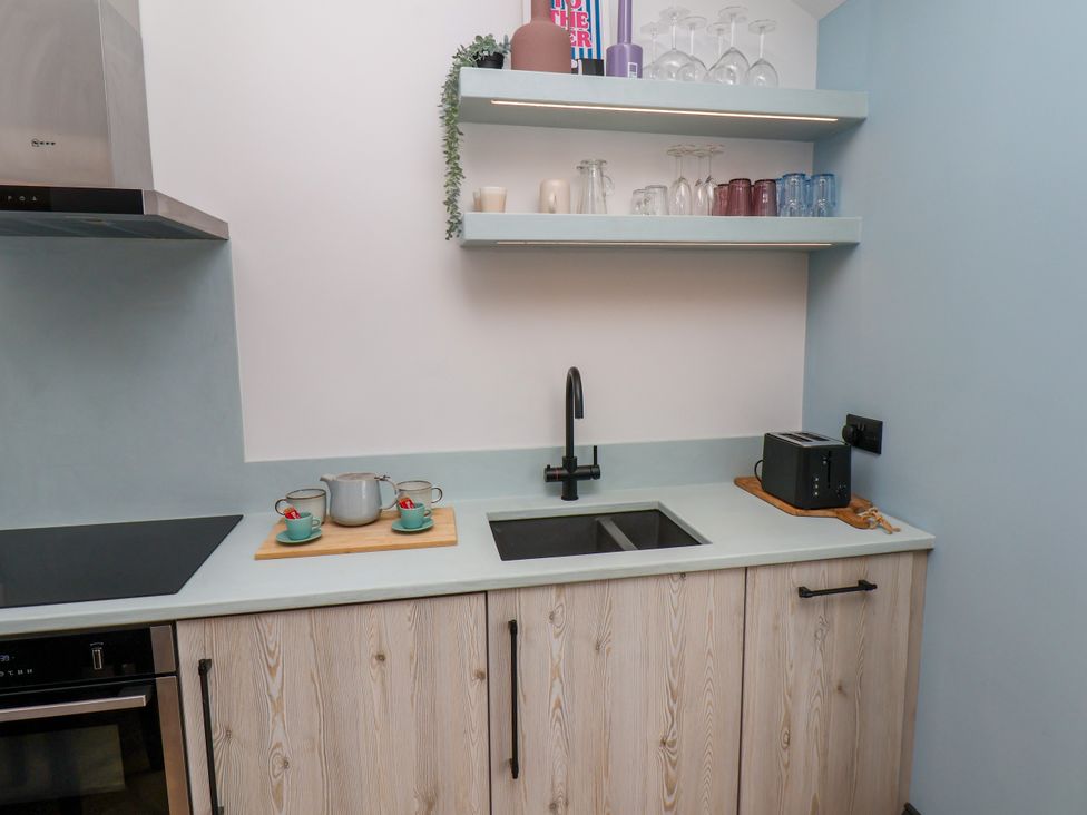 A kitchen with a sink and cooking appliances at Apartment Blue in Whitby