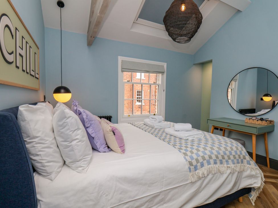 A bedroom with a bed and pillows at Apartment Blue in Whitby