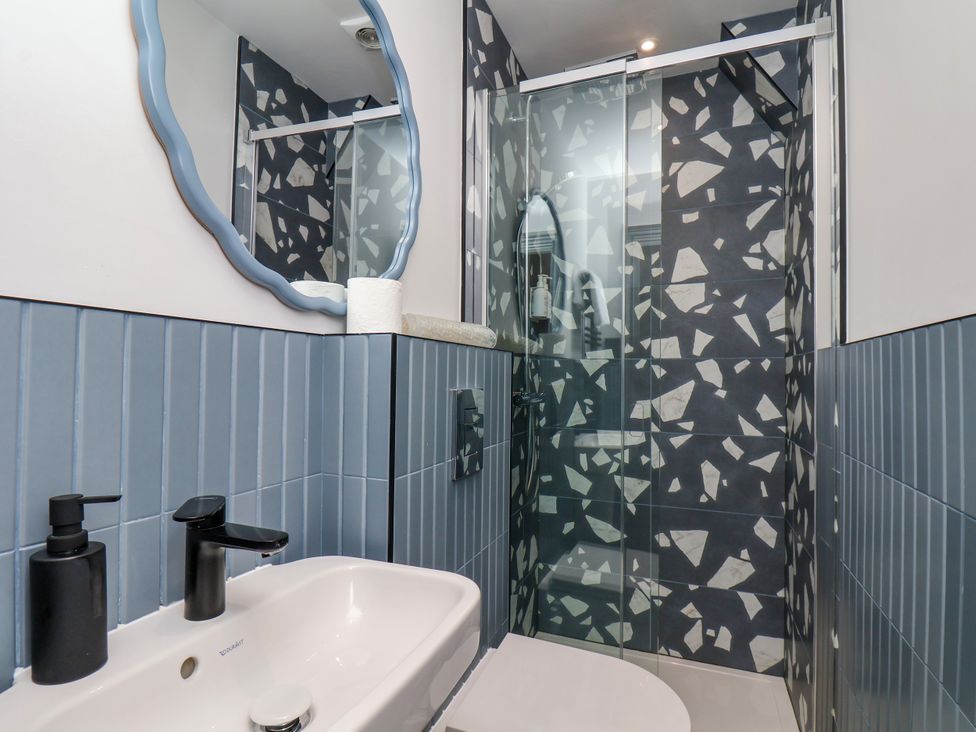 A bathroom with a shower and wash basin at Apartment Blue in Whitby