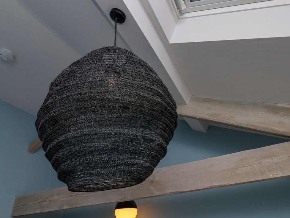 A light fixture suspended from the ceiling at Apartment Blue in Whitby