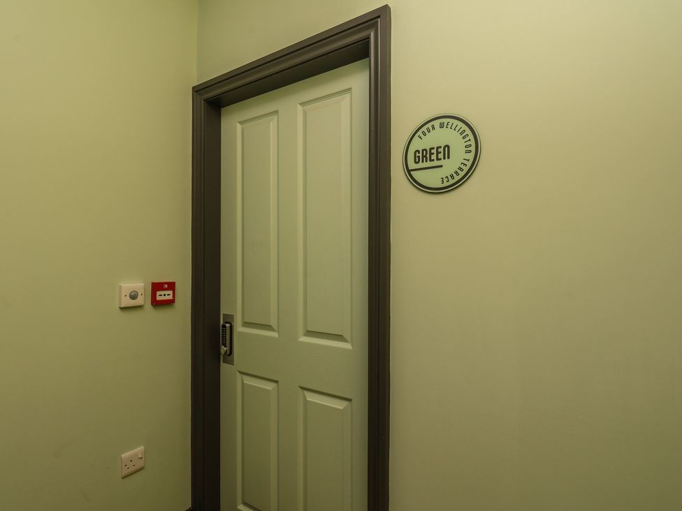 A door labeled Green in a hallway at Apartment Green in Whitby