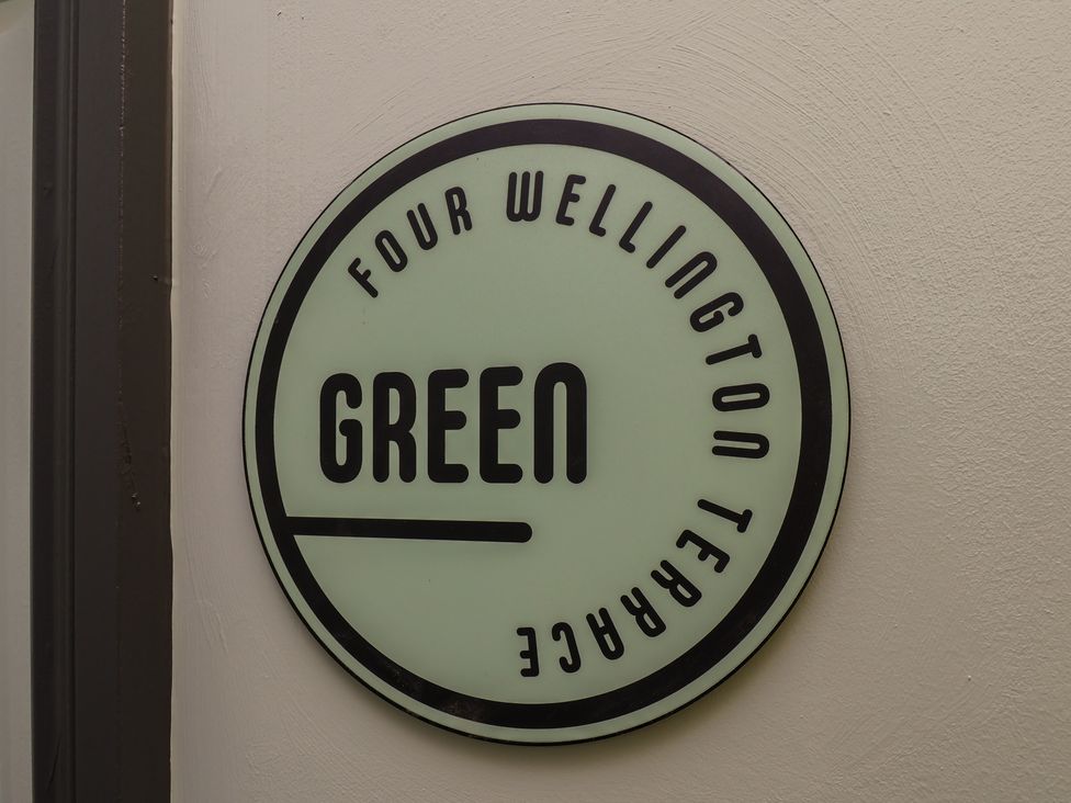 A sign displaying Four Wellington Terrace Green