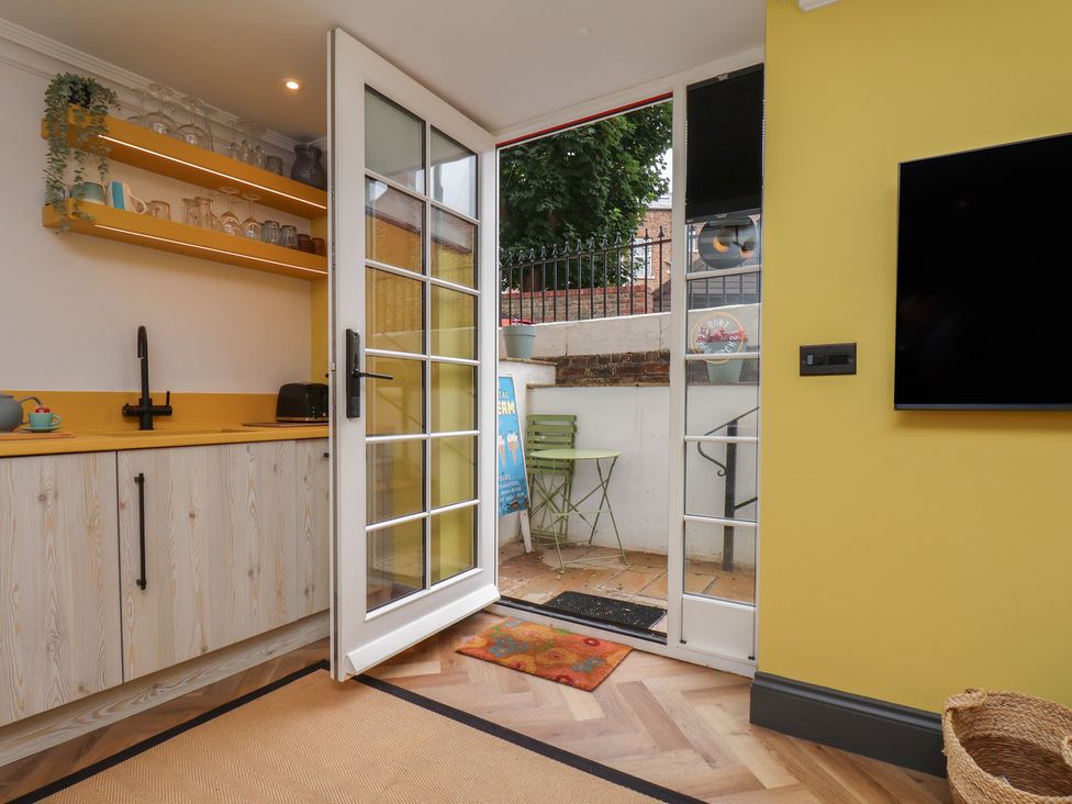 A kitchen with a counter and door leading to outdoor space at Apartment Yellow in Whitby