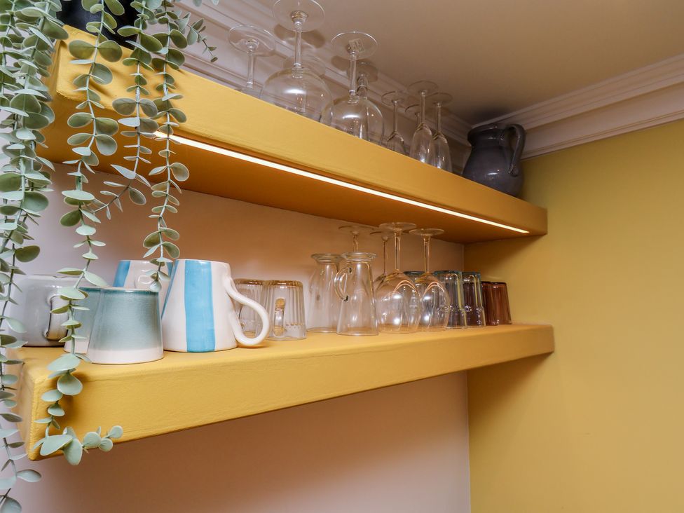 A shelf with glasses and mugs in Apartment Yellow in Whitby