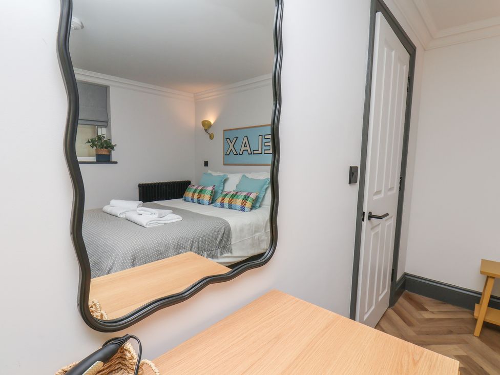 A bedroom with a bed and decorative pillows at Apartment Yellow in Whitby