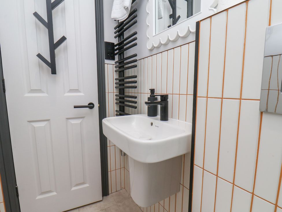 A bathroom with a sink and mirror at Apartment Yellow in Whitby