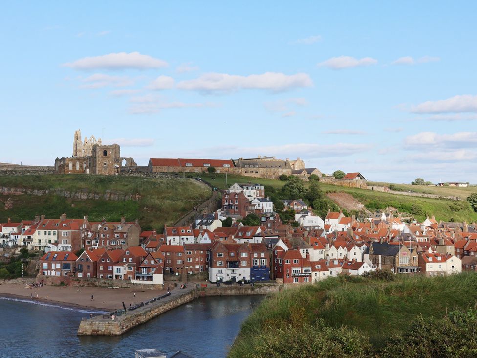 A coastal view with houses and castle ruins at Apartment Yellow in Whitby