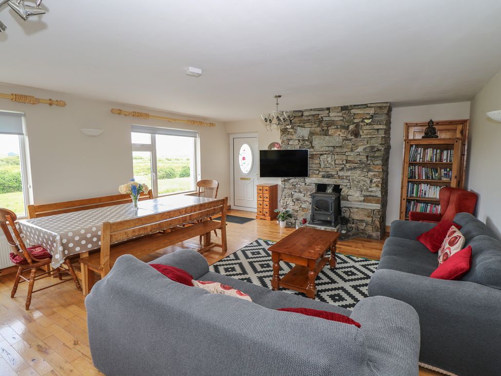 A living room with a dining table and sofa at Islands Inn in Louisburgh, County Mayo