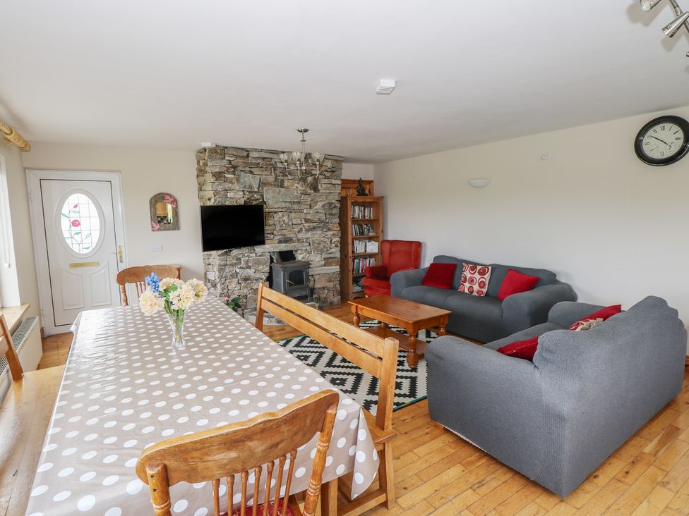 A living room with a sofa and dining table at Islands Inn in Louisburgh, County Mayo