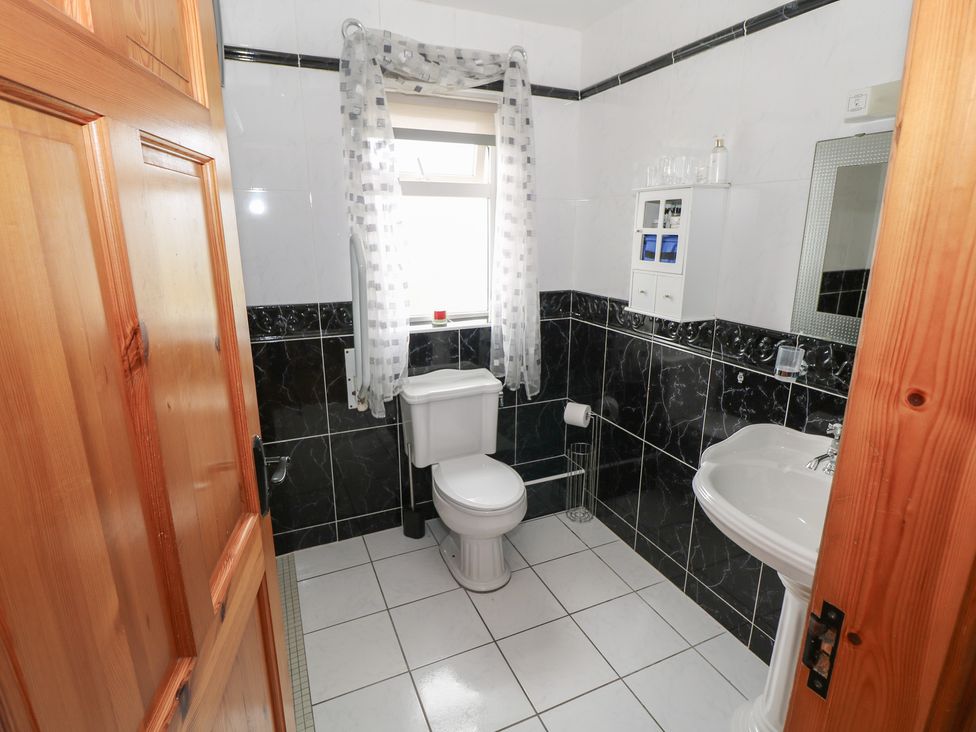 A bathroom with a toilet and sink at Islands Inn in Louisburgh, County Mayo