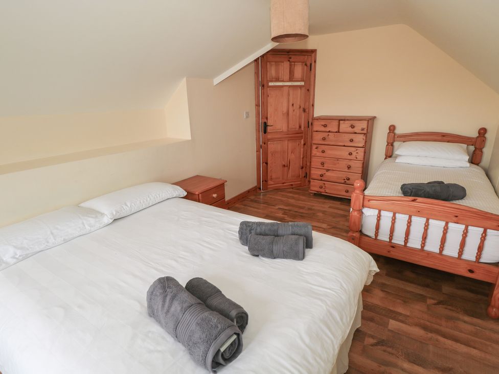 A bedroom with a double bed and a twin bed at Islands Inn in Louisburgh, County Mayo