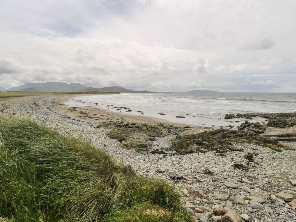 A beach with rocks and grass at Islands Inn, Louisburgh, County Mayo