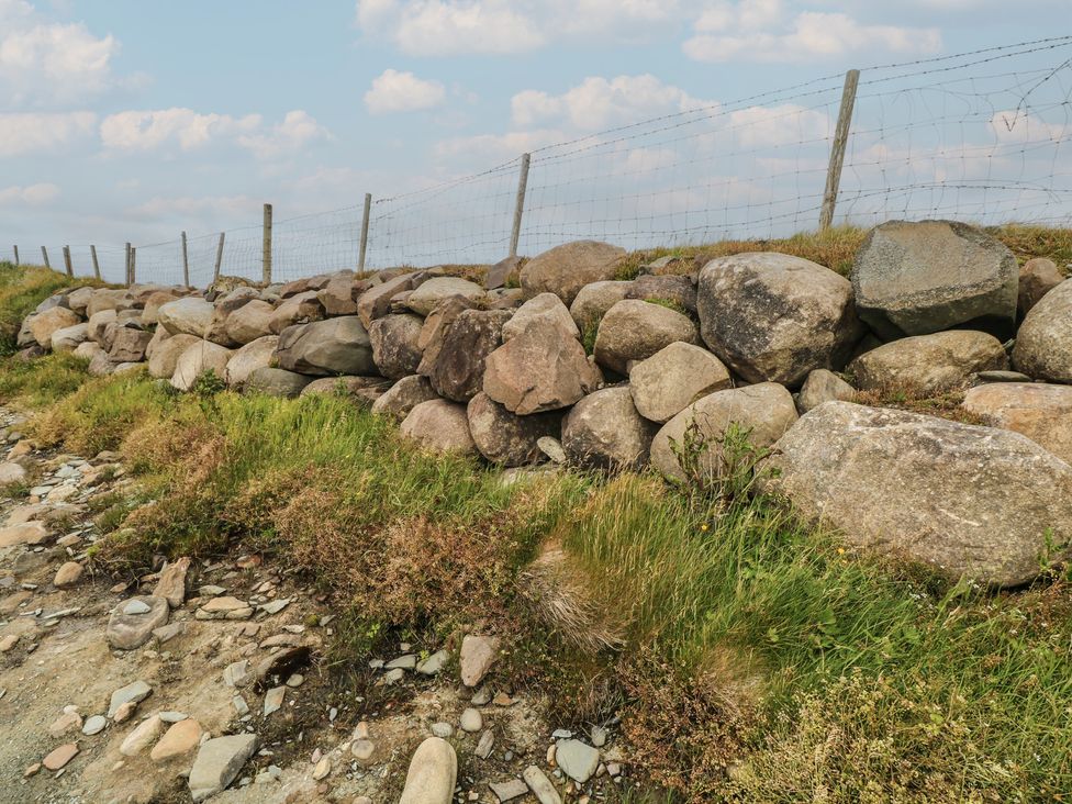 A stone wall with fence and grass at Islands Inn in Louisburgh, County Mayo