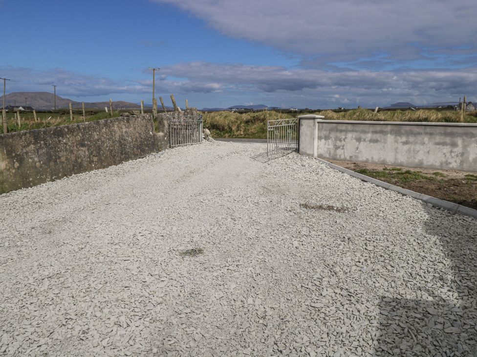 An outdoor area with a gravel driveway and a gate at Islands Inn Louisburgh, County Mayo