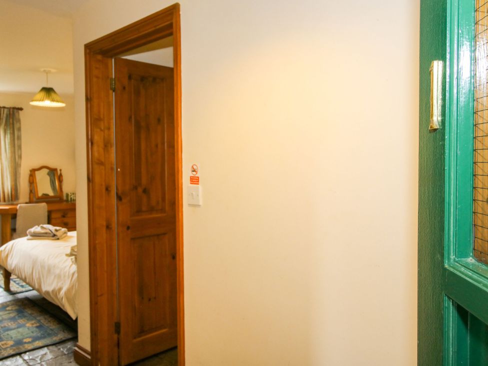 A bedroom with a bed and a mirror at Apartment 1 in Lydbury North