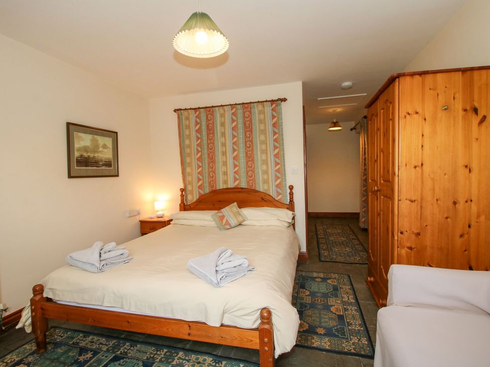 A bedroom with a bed and wardrobe at Apartment 1 in Lydbury North