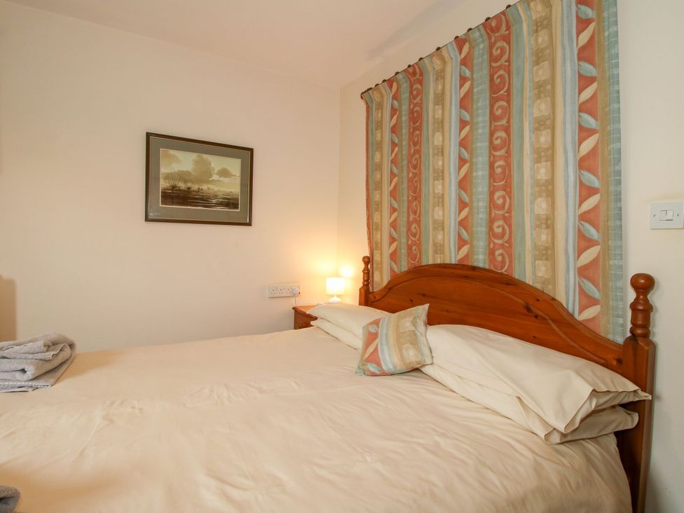 A bedroom with a bed and wall decor at Apartment 1 in Lydbury North