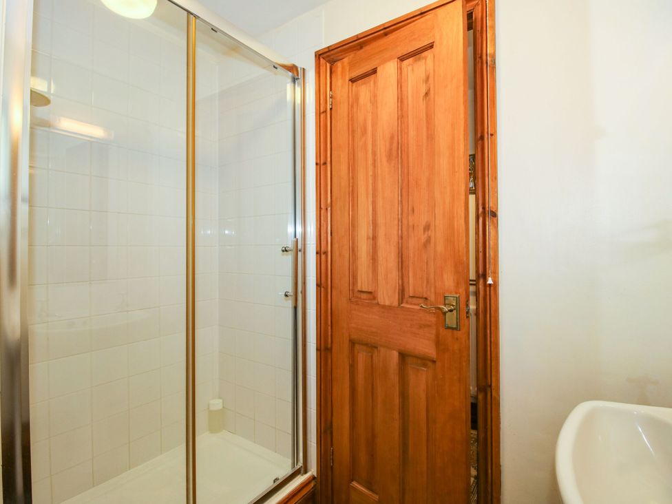 A bathroom with a shower and a bathtub at Apartment 1 in Lydbury North