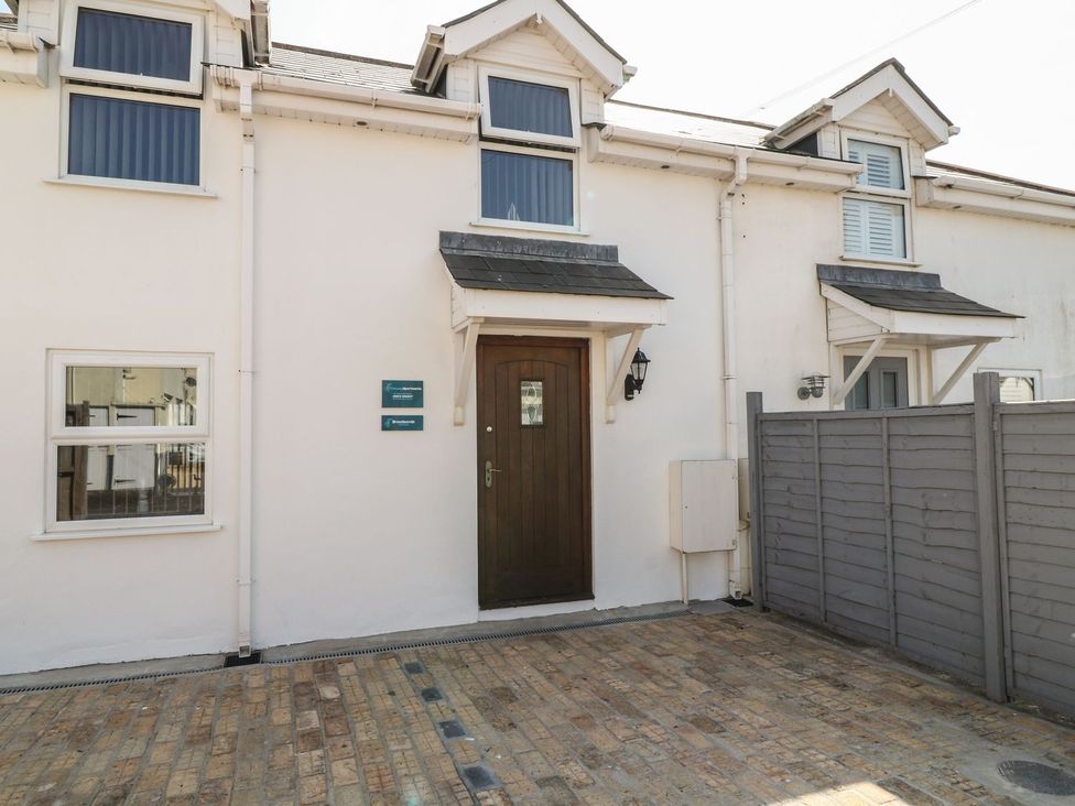 A front entrance with a door and windows at Broadsands Cottage in Paignton