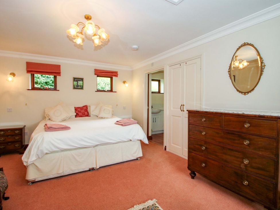 A bedroom with a bed and dresser at Willow Cottage in Lydbury North