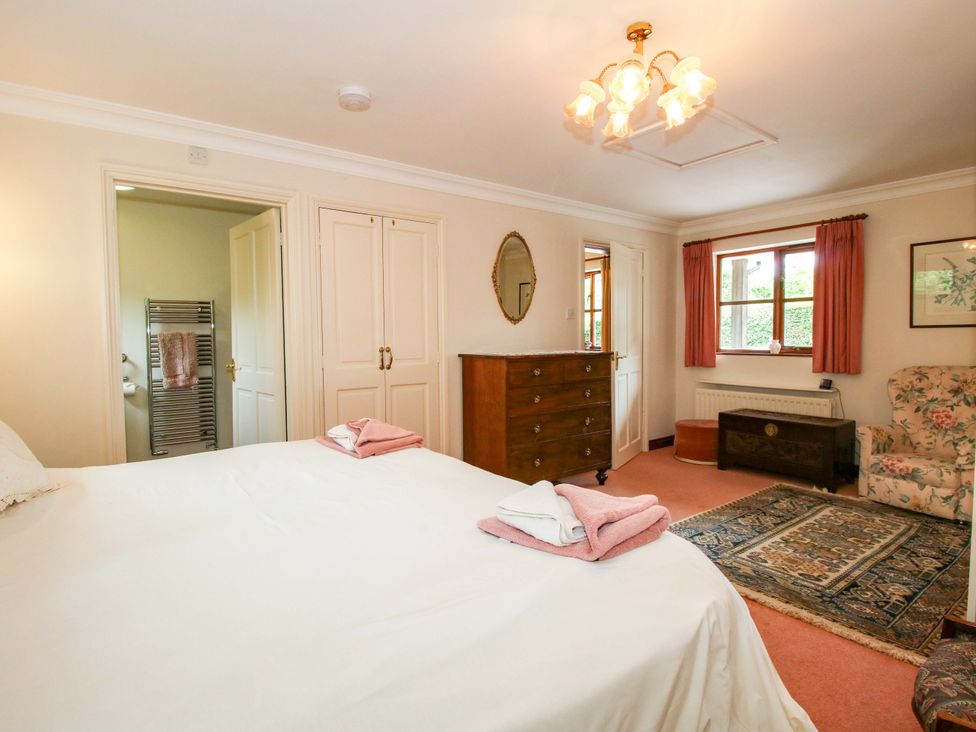 A bedroom with a bed and dresser at Willow Cottage in Lydbury North
