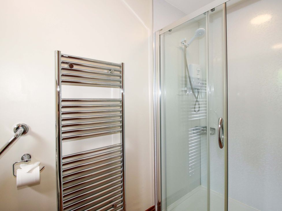 A bathroom with a shower and towel rail at Willow Cottage in Lydbury North