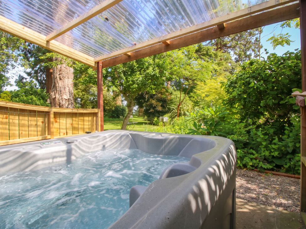 A hot tub in an outdoor area at Apple Bough Cottage Hereford
