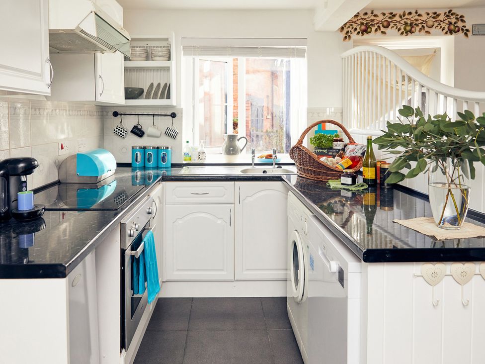 A kitchen with appliances and storage at Apple Bough Cottage in Kinnersley