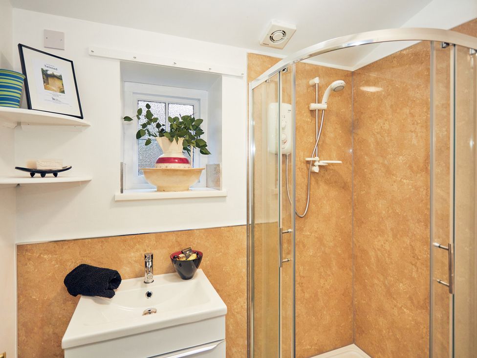 A bathroom with a shower and sink at Apple Bough Cottage Kinnersley