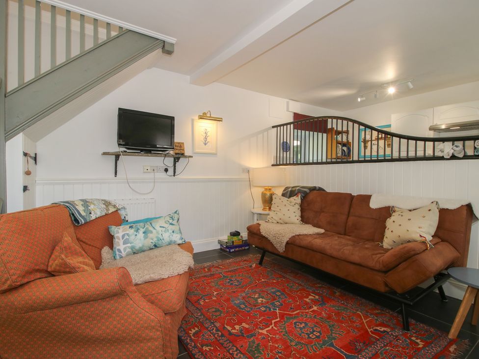A living room with a sofa and television at Chess Cottage Weobley