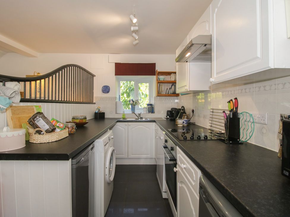 A kitchen with a sink and appliances at Chess Cottage in Weobley