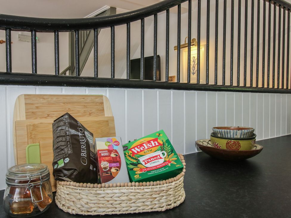 A kitchen counter with a cutting board and various food items at Chess Cottage Weobley