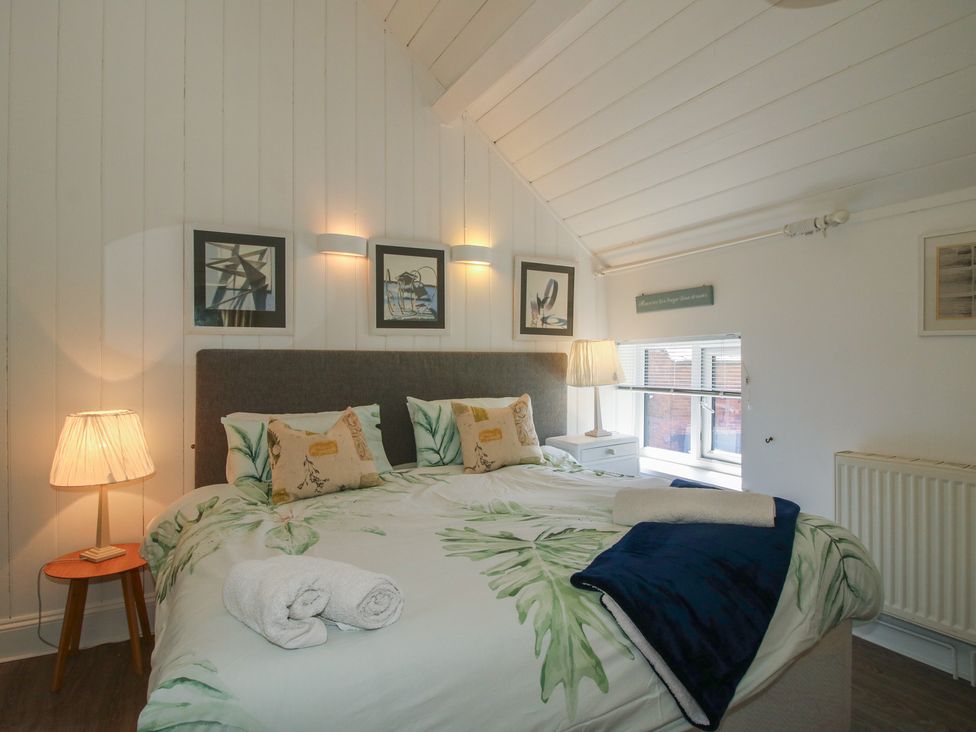 A bedroom with a bed and bedside lamp at Chess Cottage Weobley