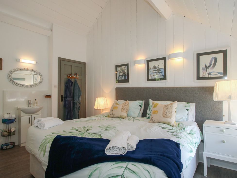 A bedroom with a bed and bedside table at Chess Cottage in Weobley