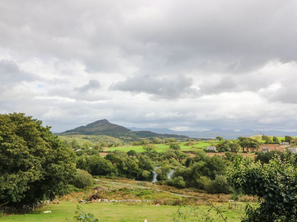 A landscape with a mountain and trees at Bwthyn Bach in Pentrefelin