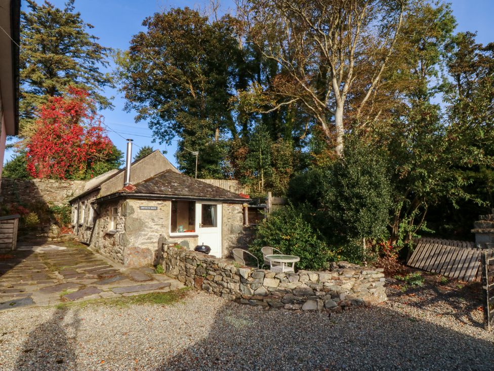 An outdoor area with a stone building and pathway at Bwthyn Bach in Pentrefelin
