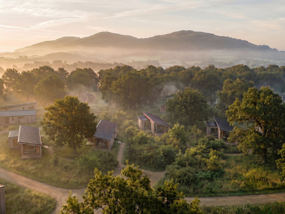 A view of cabins surrounded by trees and hills at Arbora 2.0 (Pet) Malvern