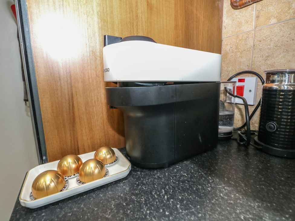 A coffee machine with capsules and a glass at The Dacha in Winchester