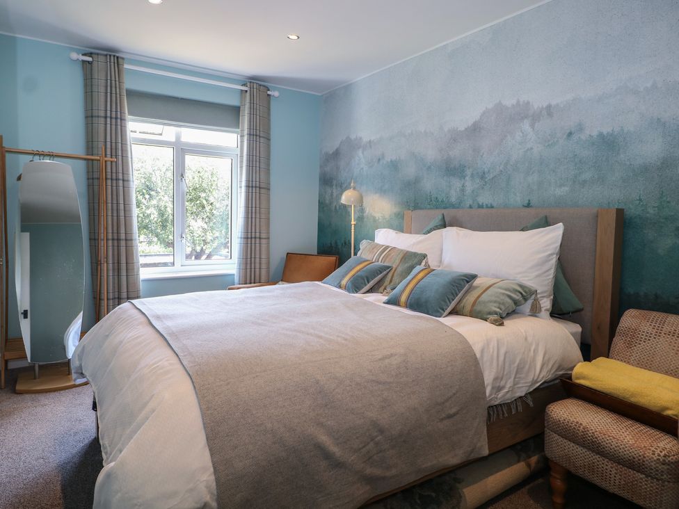 A bedroom with a bed and a large mirror at The Dacha in Winchester