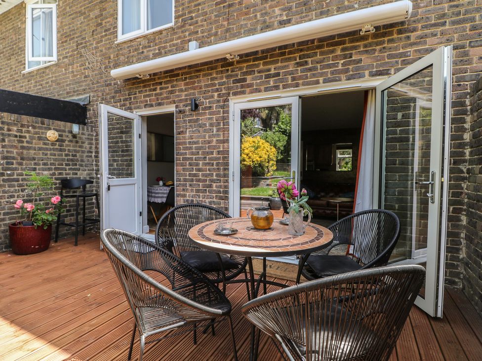 An outdoor patio with a table and chairs at The Dacha in Winchester