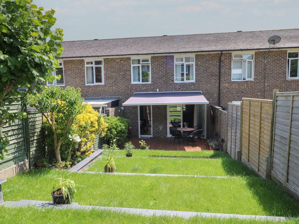 A garden with grass and seating area at The Dacha in Winchester