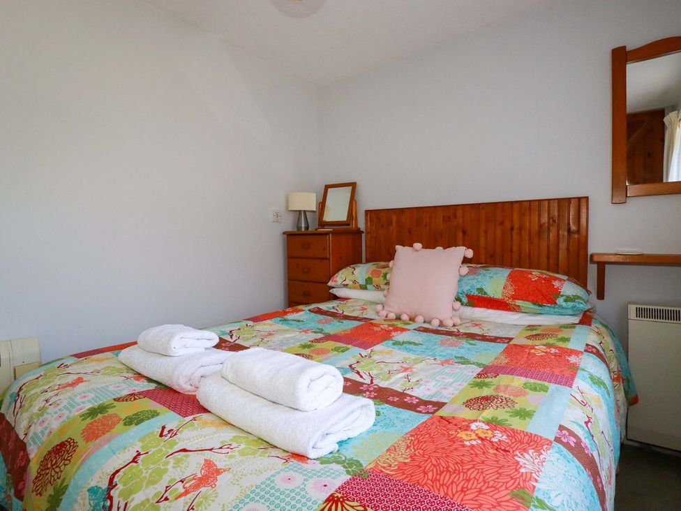 A bedroom with a double bed and dressing table at Chyancrowse in Penzance